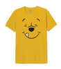 T-shirt Disney - WINNIE SMILE jaune avec imprimé du visage joyeux de Winnie l'ourson. Haut en coton confortable, parfait pour les amateurs de vêtements sous licence Disney.